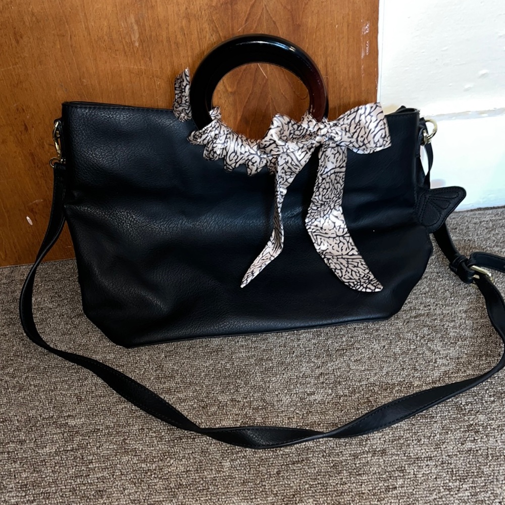 Black Max Studios tote with shoulder strap, wood handles and butterfly keychain